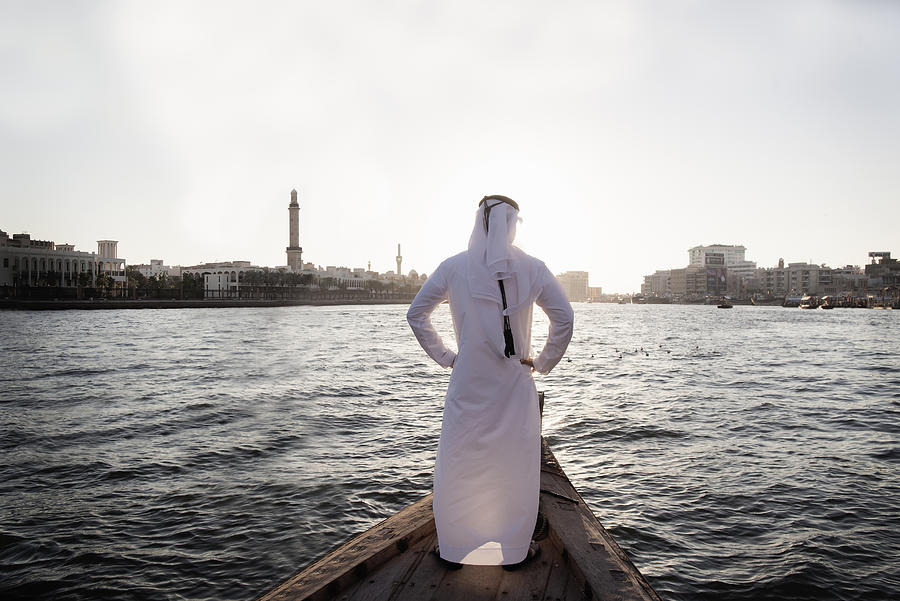 Arab businessman in traditional dress, Dubai Creek Photograph by Gary John Norman
