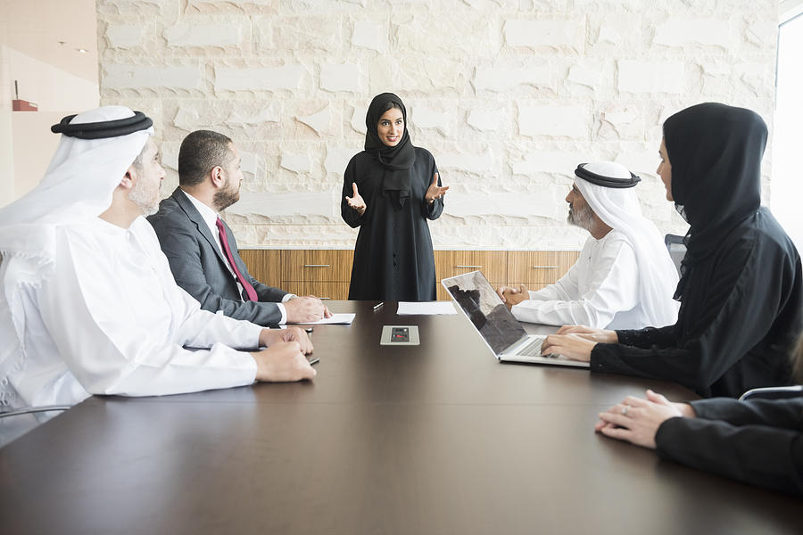 Arab businesswoman giving presentation to colleagues in office Photograph by JohnnyGreig