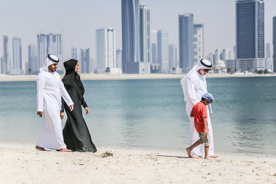Arab family walking on the autumn beach Photograph by Oonal