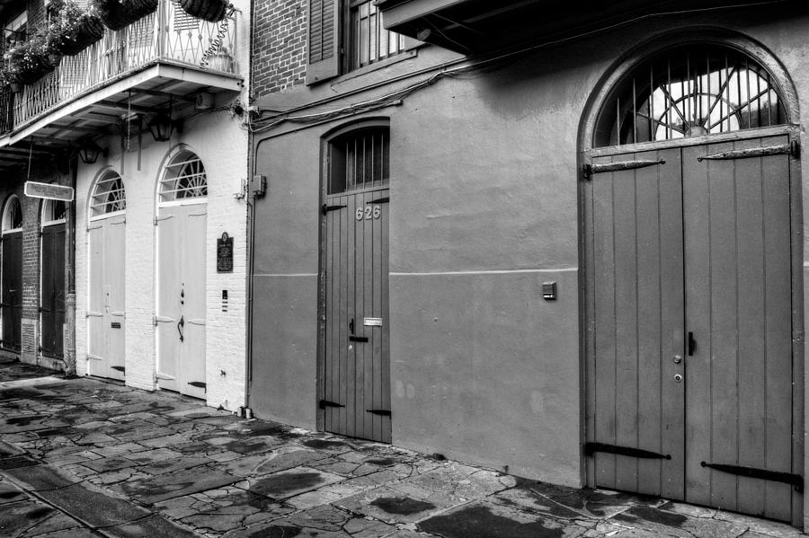 New Orleans Photograph - Arched Doors of Pirates Alley in Black and White by Greg and Chrystal Mimbs
