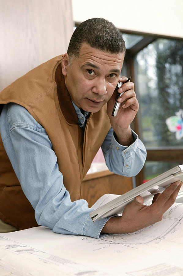 Architect talking on cell phone Photograph by Comstock Images