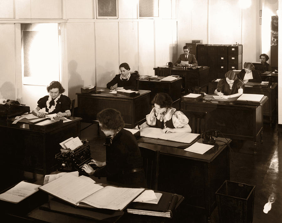 Archive Shot / Group Of Office Workers Sitting At Their Desks Photograph by Fpg