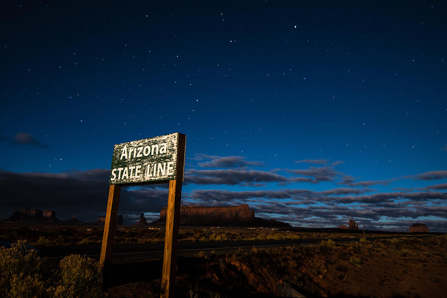Arizona State Line in Monument Valley at Night Photograph by Todd Aaron