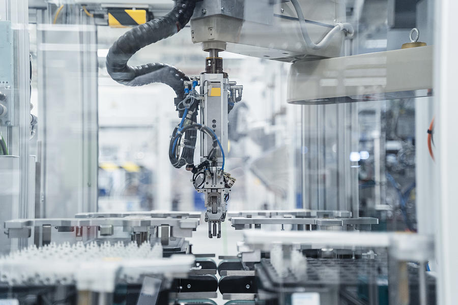 Arm of assembly robot functioning inside modern factory, Stuttgart, Germany Photograph by Westend61