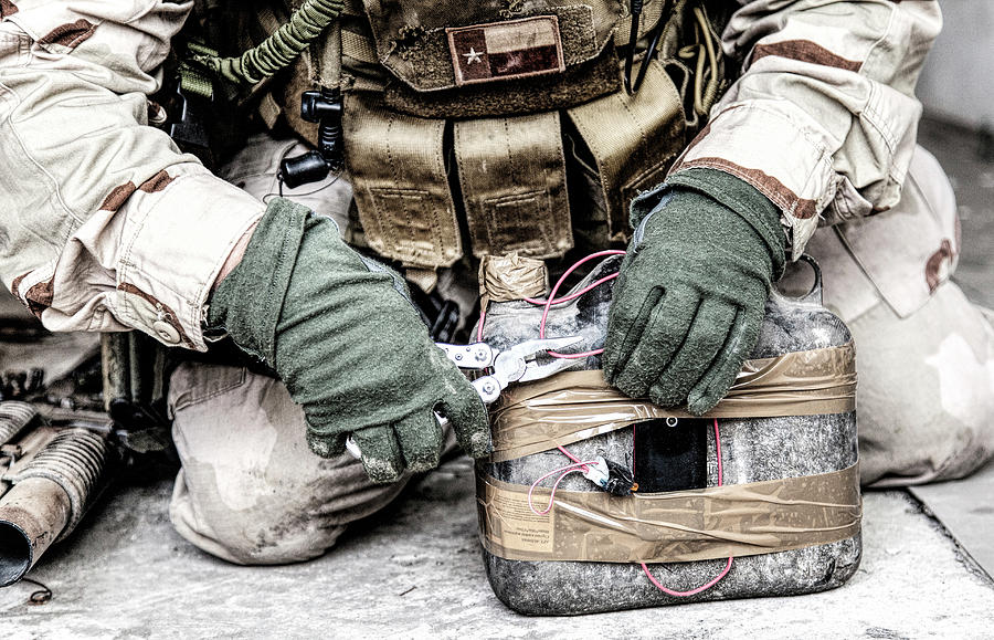 Army Soldier Using Pliers To Cut Wires Photograph by Oleg Zabielin