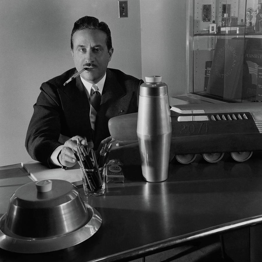 Artist Raymond Loewy Sitting At His Desk Photograph by Luis Lemus