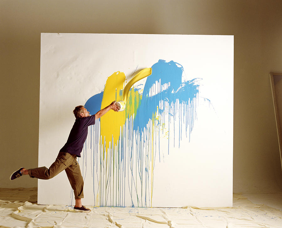 Artist Throwing Paint At Canvas Photograph by Vital Pictures