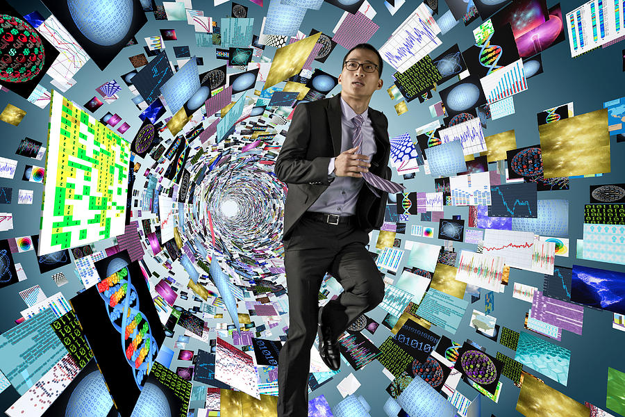 Asian businessman surrounded by science images Photograph by Jon Feingersh Photography Inc