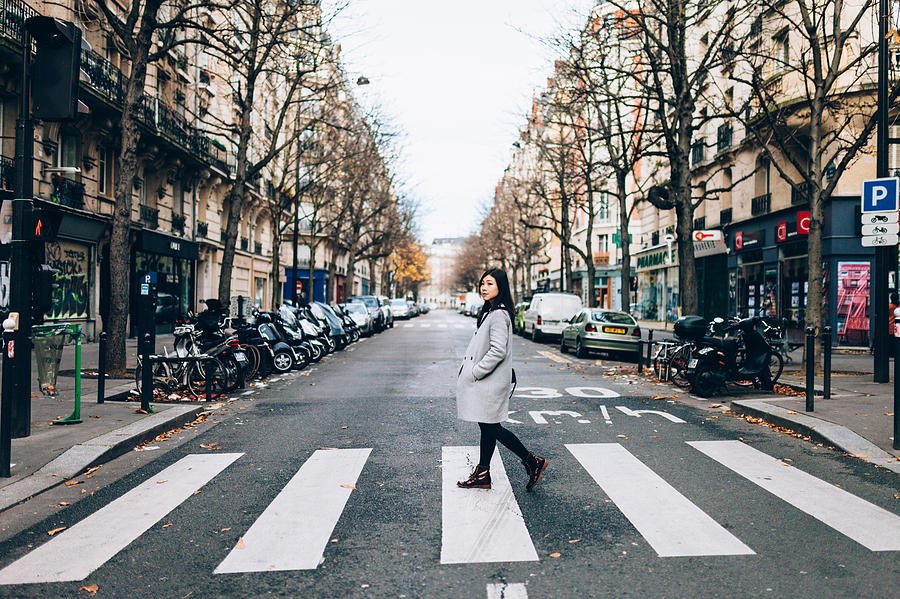 Asian woman crossing zebra in Paris Photograph by Oscar Wong