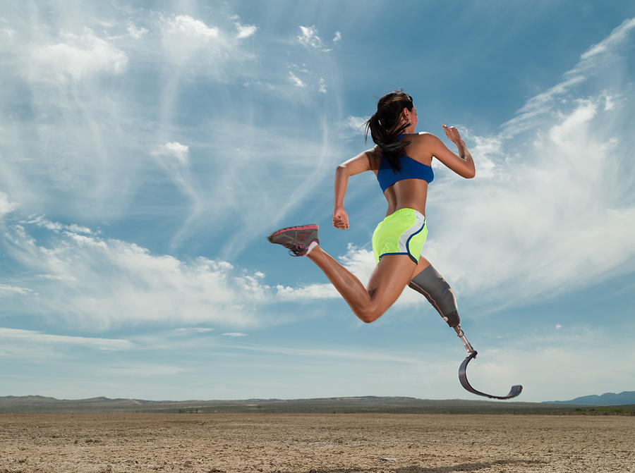 Asian Women With Prosthetic Leg Running In The Desert Photograph by MichaelSvoboda