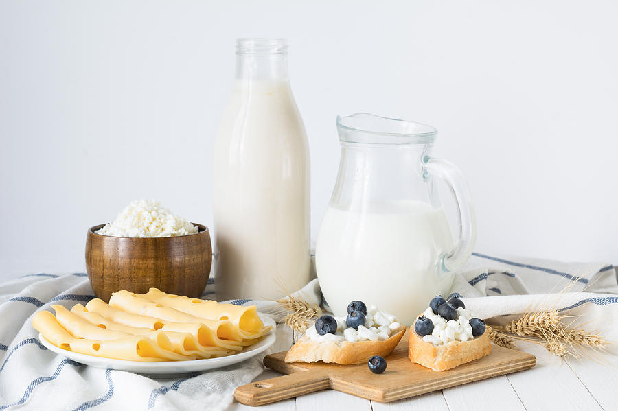 Assorted farmers dairy products on white table Photograph by Arx0nt
