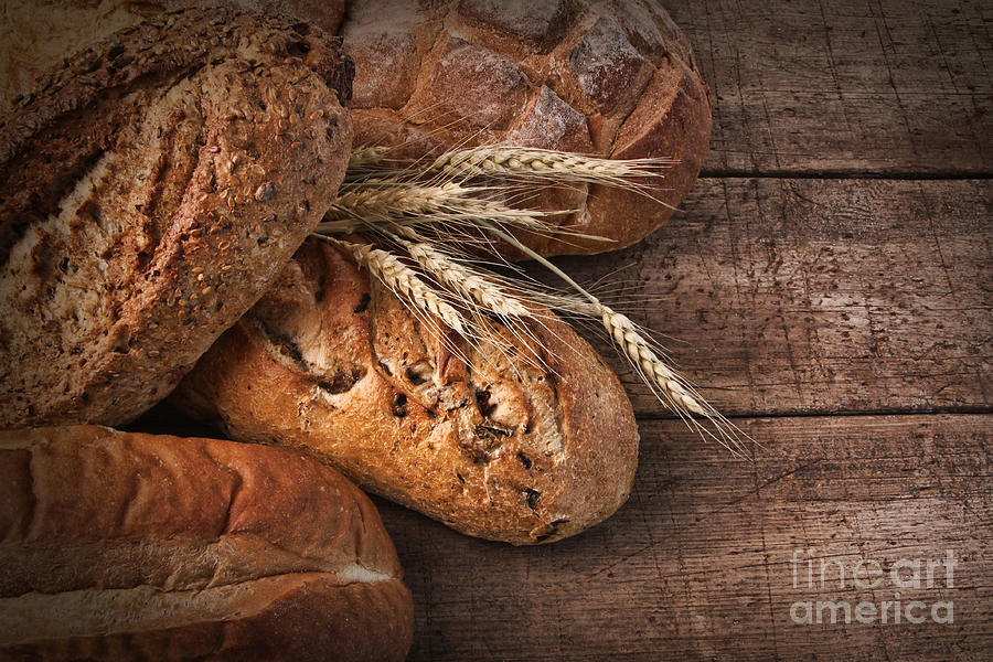 Assortment of loaves of bread on wood Photograph by Sandra Cunningham