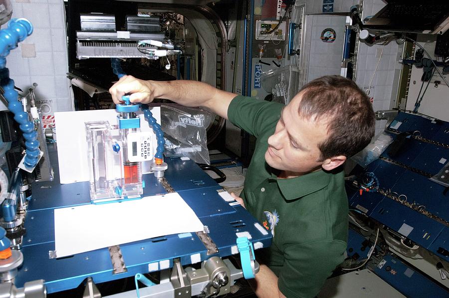 Astronaut Conducting Experiment On Iss Photograph by Nasa