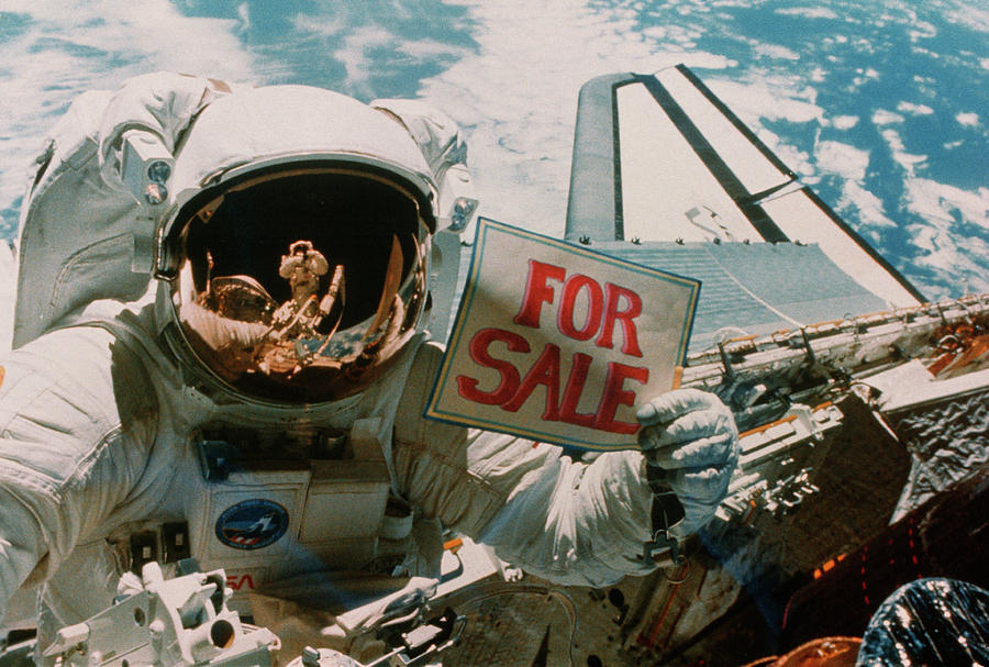Astronaut Holding for Sale Sign. Photograph by Nasa/science Photo Library.