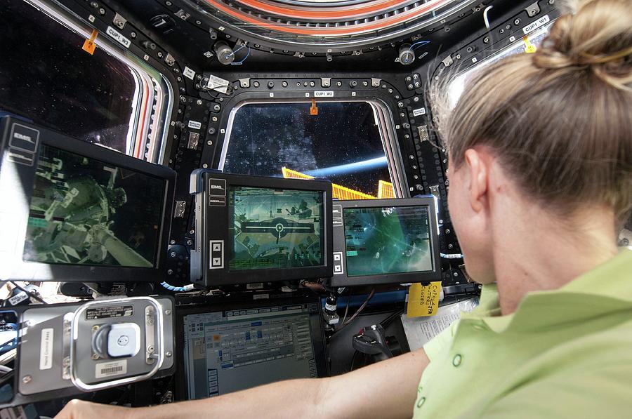 Astronaut In Iss Robotics Workstation Photograph by Nasa