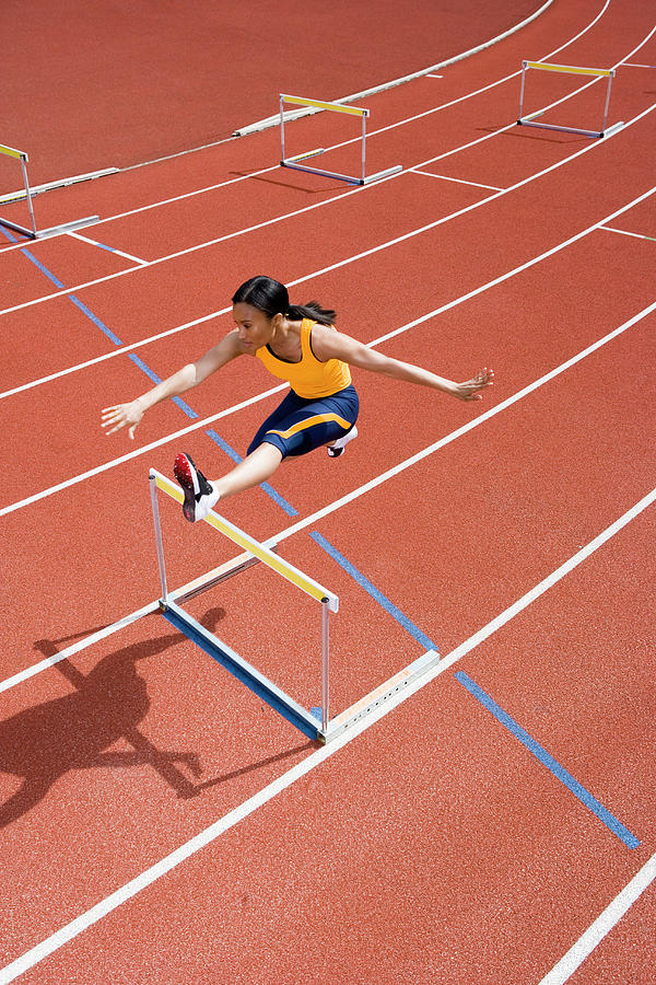 Sports Photograph - Athlete Jumping Over A Hurdle by Gustoimages/science Photo Library