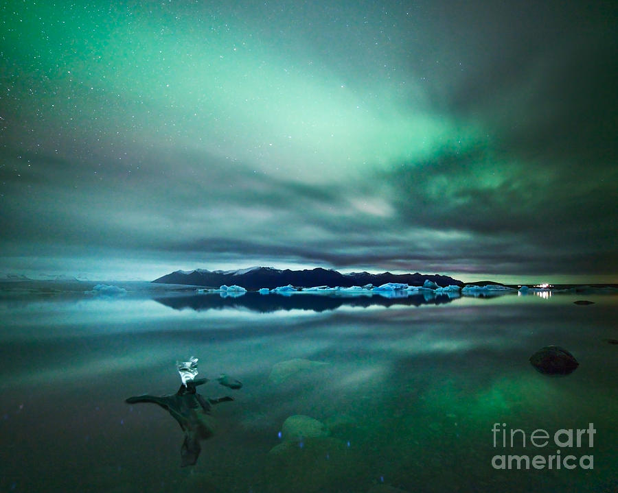 Aurora borealis Northern lights over glacial lagoon in Iceland Photograph by Matteo Colombo