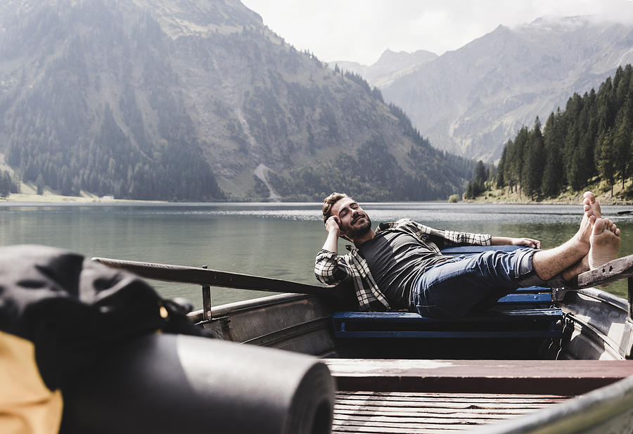 Austria, Tyrol, Alps, relaxed man in boat on mountain lake Photograph by Westend61