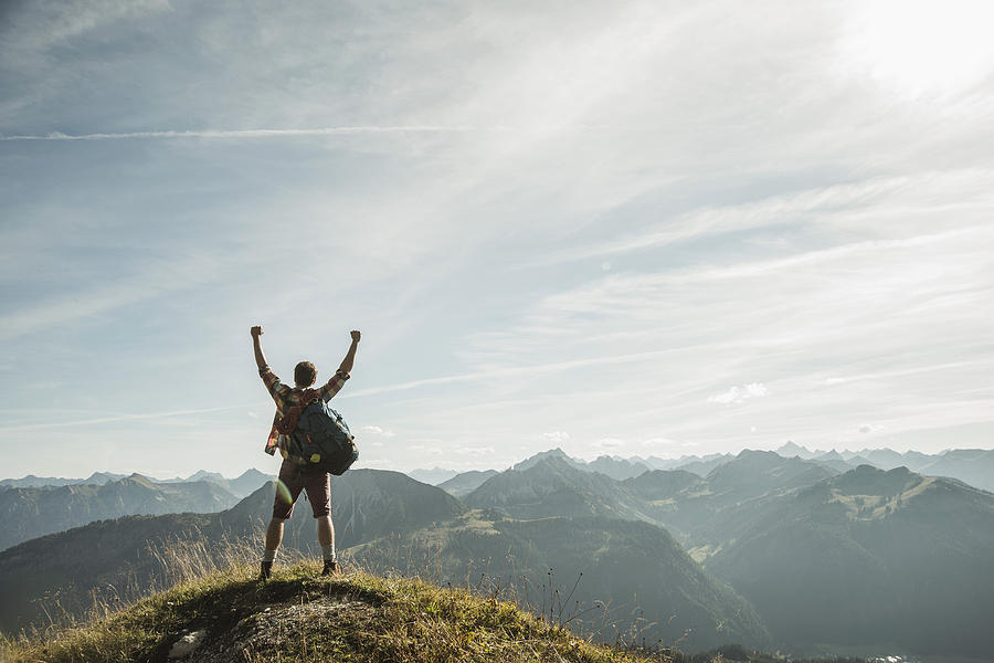 Austria, Tyrol, Tannheimer Tal, young man cheering on mountain top Photograph by Westend61