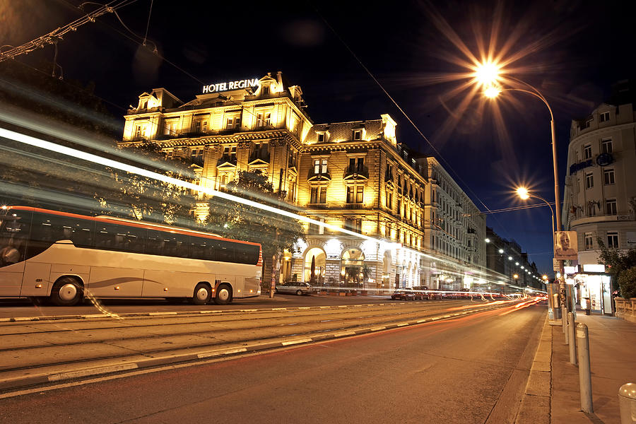 Austria, Vienna, coach travelling along road in city, night Photograph by Allan Baxter