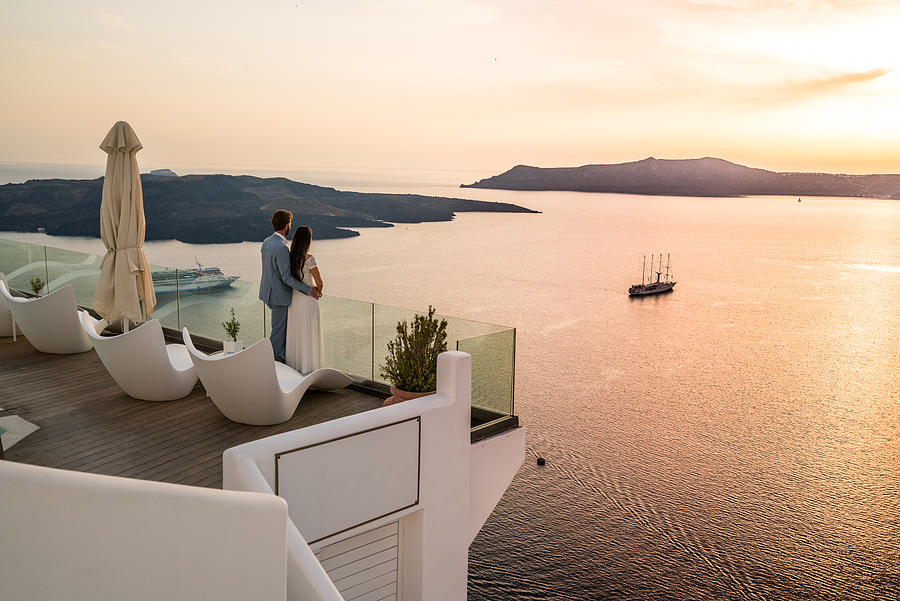 Authentic Wealth - rich couple standing on terrace with amazing sea view Photograph by Amriphoto