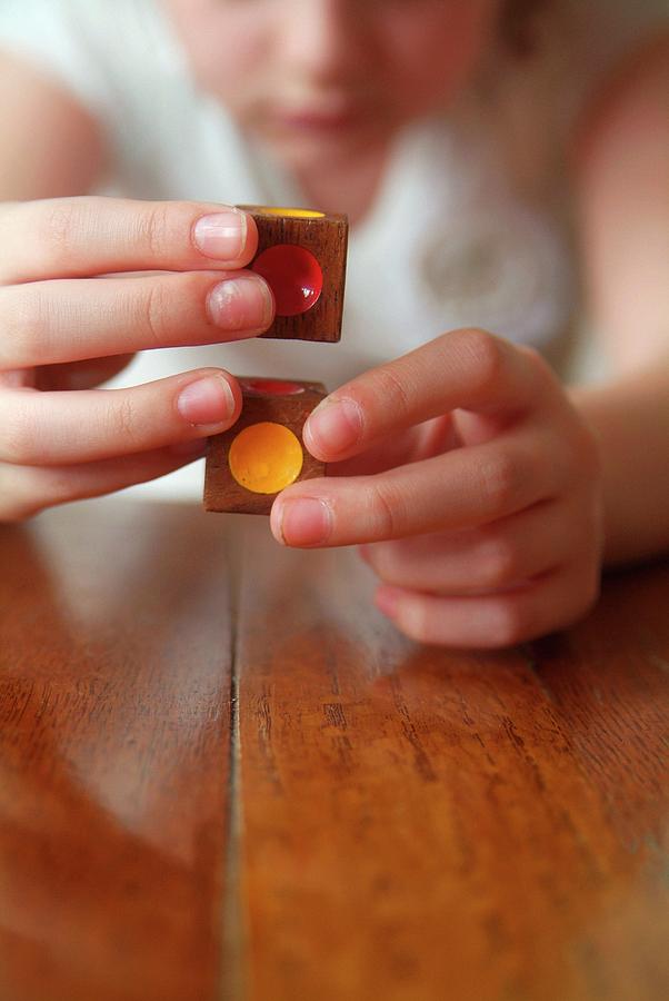 Dice Photograph - Autistic Girl Playing With Toy Blocks by Hannah Gal