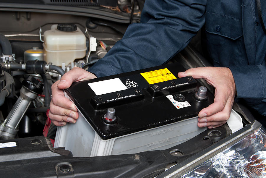 Car Photograph - Auto mechanic replacing car battery by Joe Belanger