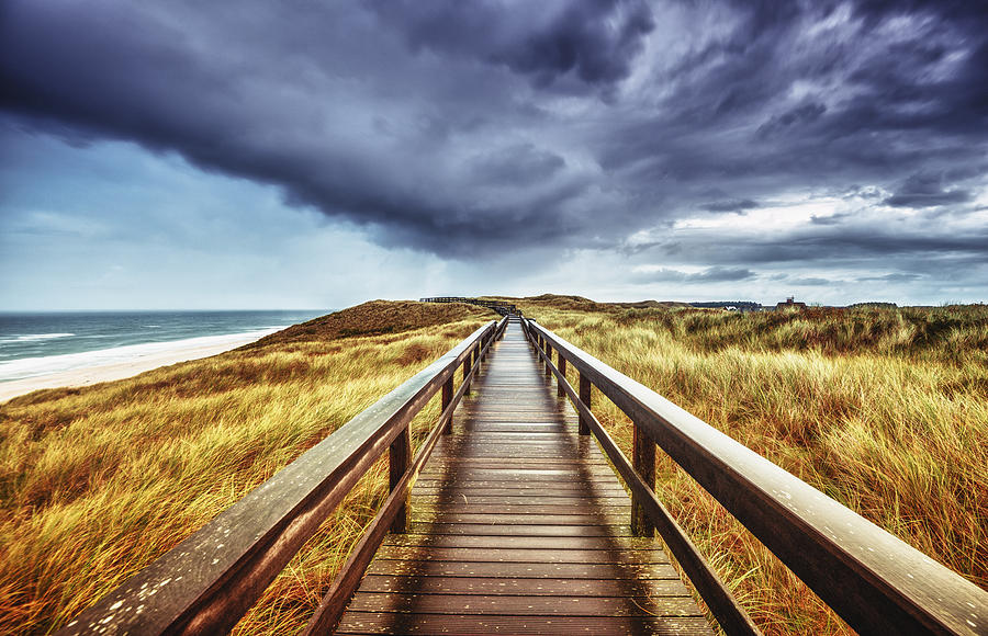 Autumn on Sylt - Wooden path under dramatic sky Photograph by Juergen Sack