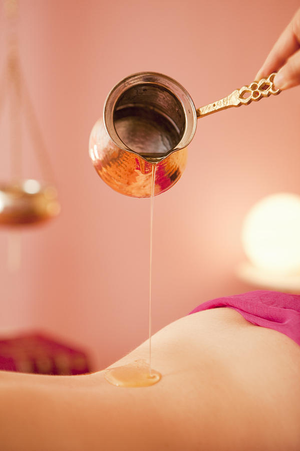 Ayurvedic oil dropping on body Photograph by Stefanie Grewel