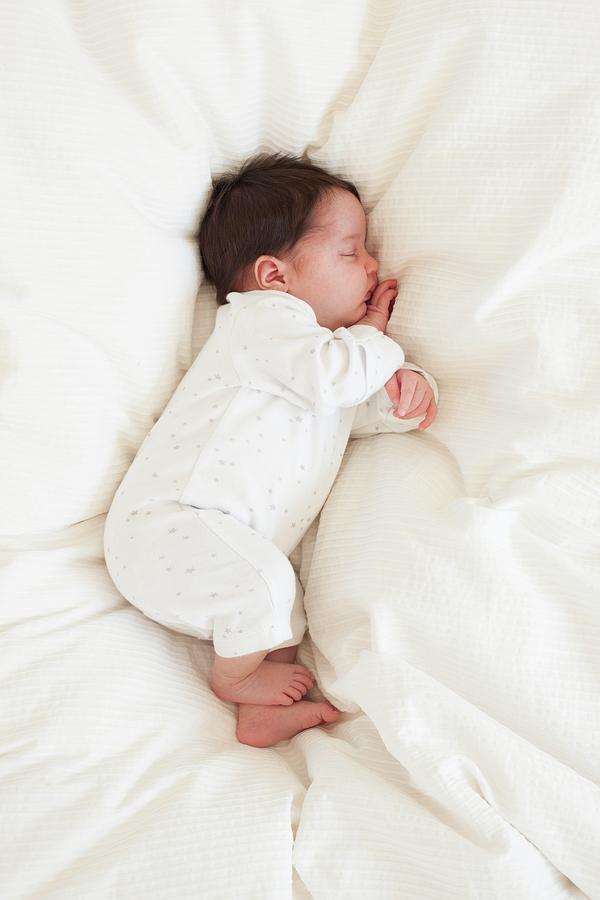 Portrait Photograph - Baby Asleep On Bed by Ian Hooton/science Photo Library