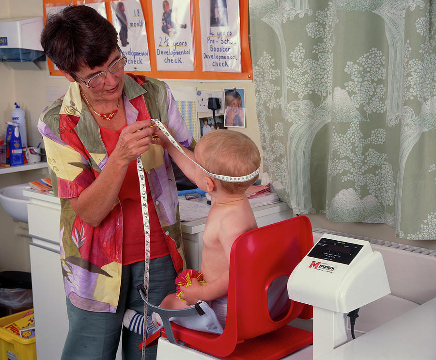 Baby Being Weighed And Measured During Checkup Photograph by Simon