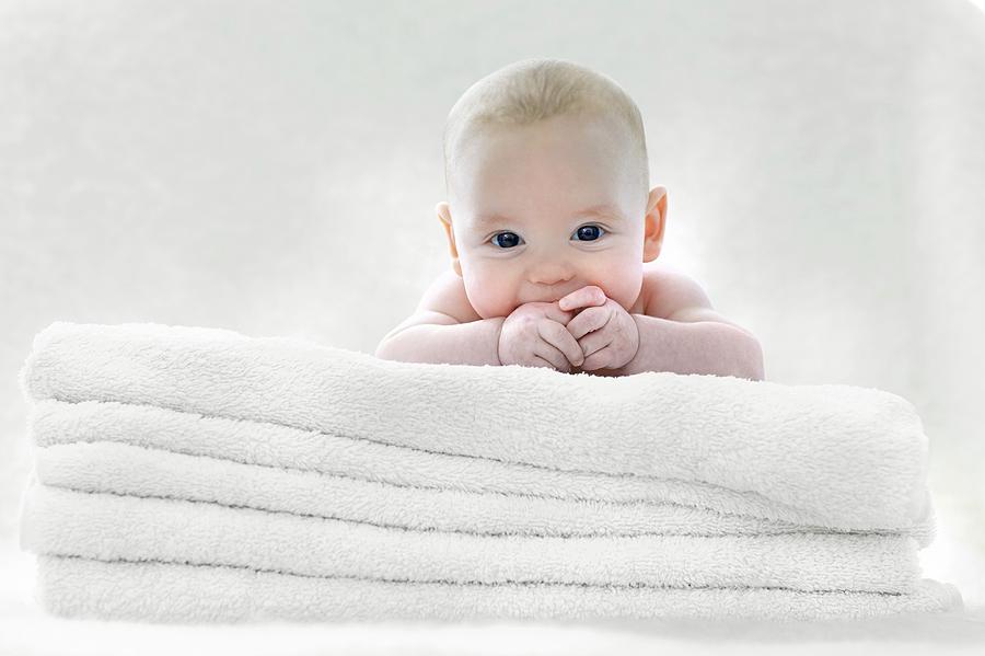 Portrait Photograph - Baby Boy Lying On Towels by Ruth Jenkinson