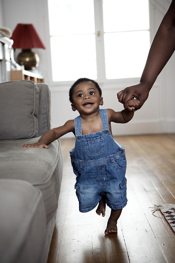 Baby Boy Taking First Steps Holding Mothers Hand Photograph by Rayes