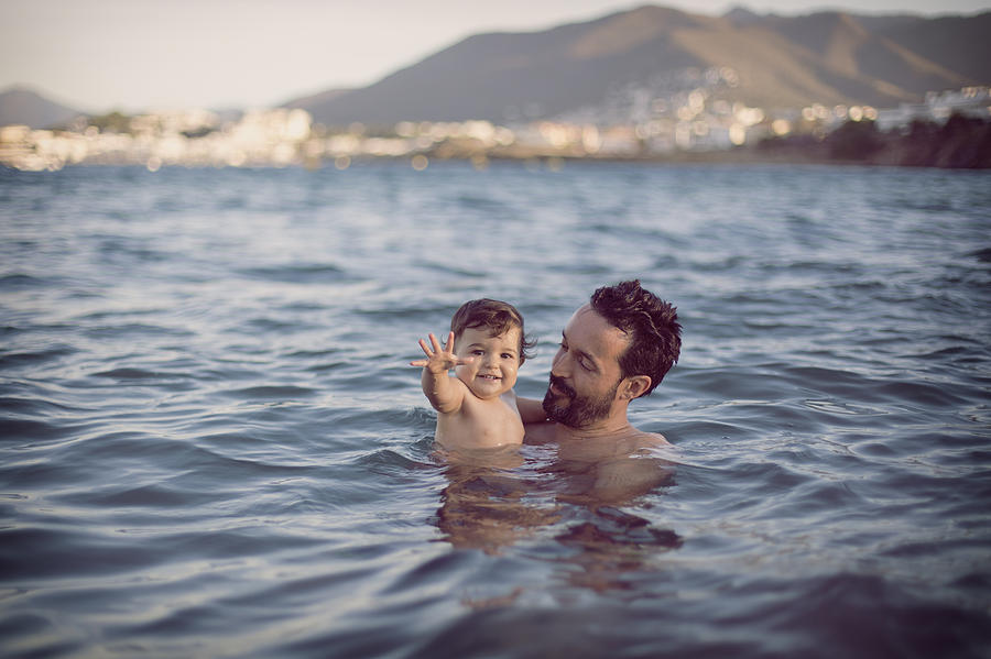 Baby girl with dad having a swim at the beach Photograph by Image taken by Mayte Torres