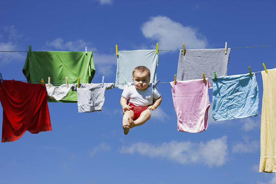 Baby Hanging To A Drying Clothing Rope Photograph by Buena Vista Images