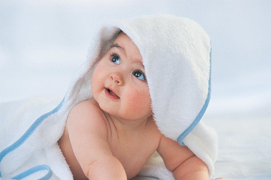 Baby Looking Up With a Towel Covering its Head Photograph by Digital Vision.