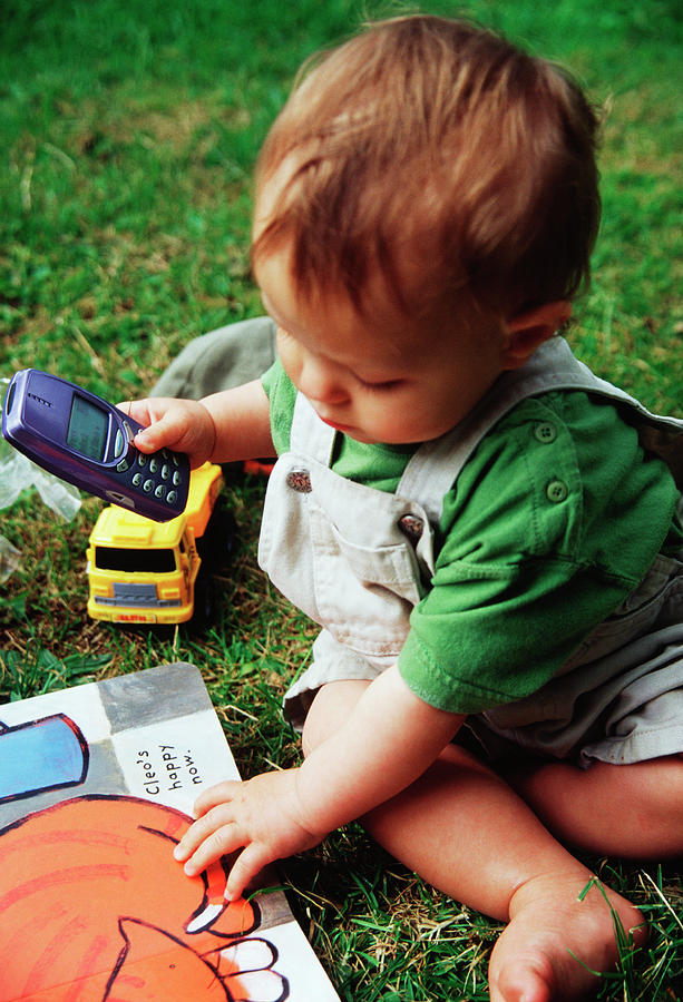 Baby Playing With Mobile Phone Photograph by Tracy Rutter/science Photo Library