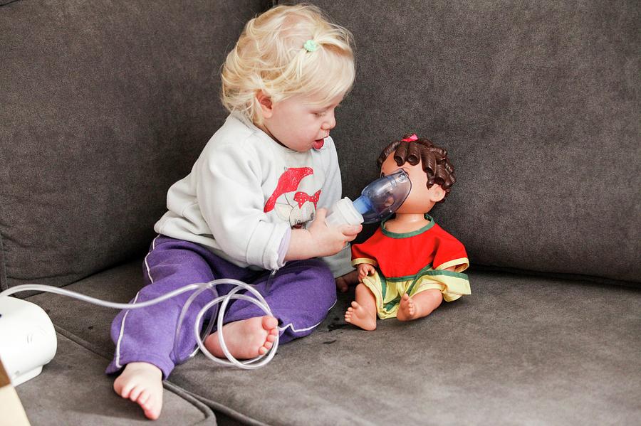 Baby Uses An Inhalation Mask On Her Doll Photograph by Photostock-israel