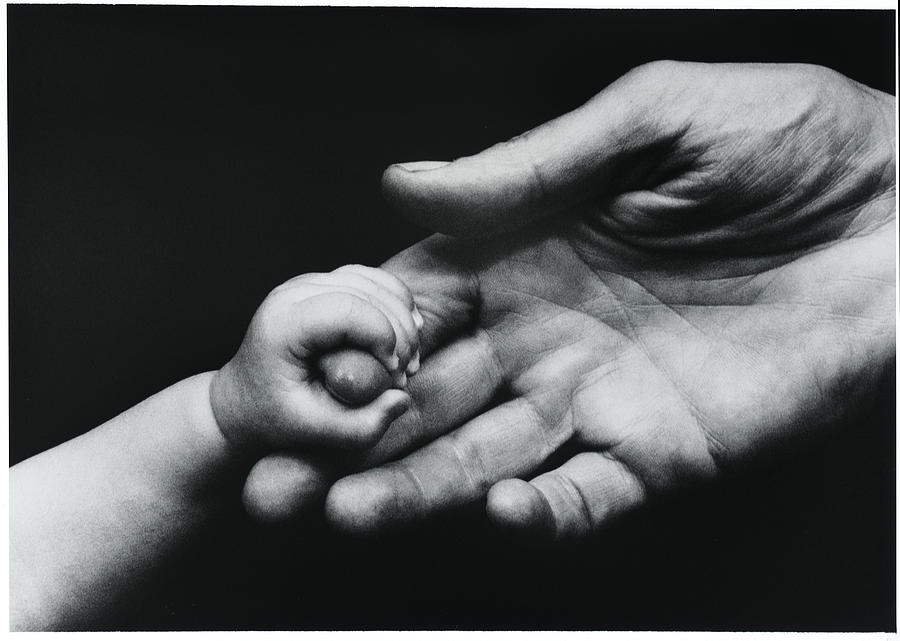 Baby's Hand Grasping The Finger Of An Adu Photograph by Simon Fraser ...