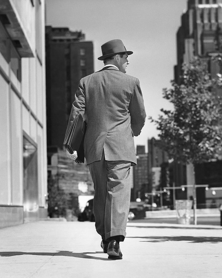 Back view of man walking on street Photograph by Stockbyte