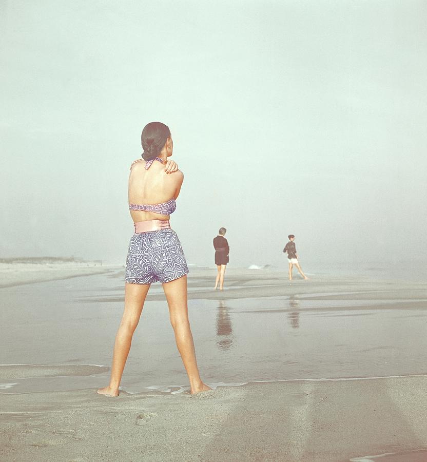 Back View Of Three People At A Beach Photograph by Serge Balkin