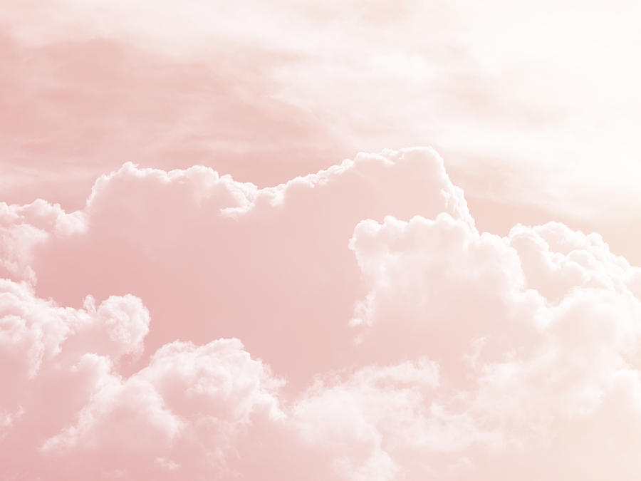 Background of a sky of pink soft color with white clouds. Photograph by Jose A. Bernat Bacete
