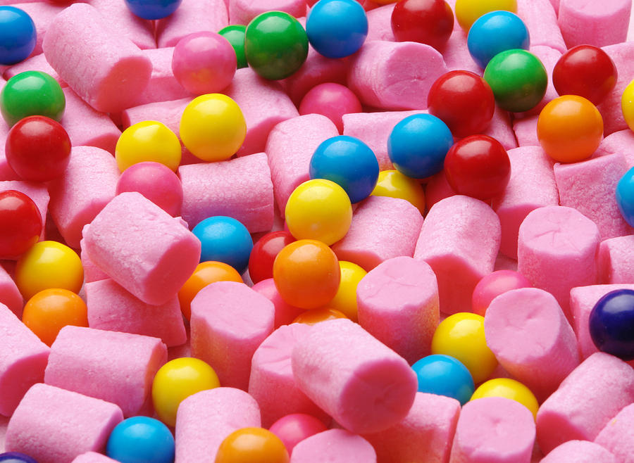 Background of pink cylinder shaped gum and colorful gumballs Photograph by GreenPimp