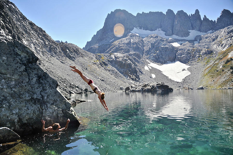 Nature Photograph - Backpackers Diving Into Alpine Lake by HagePhoto