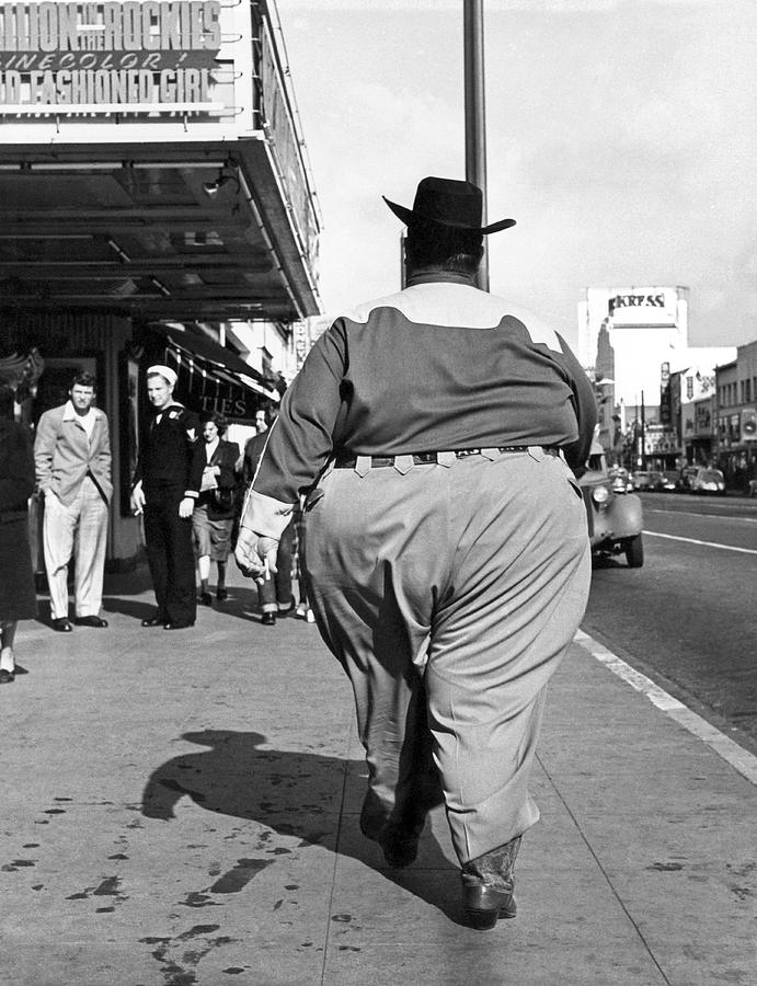 Black And White Photograph - Backside of Hefty Cowboy by -