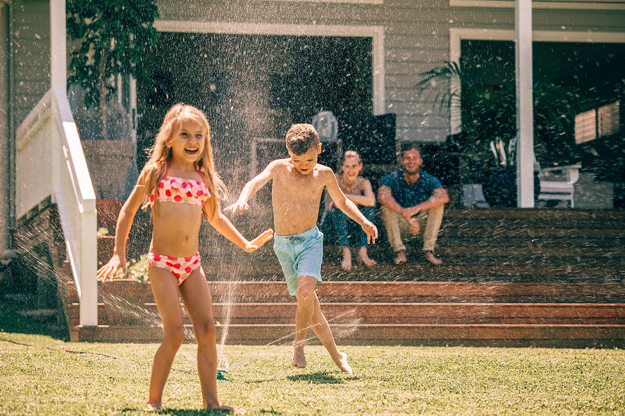 Backyard Fun With The Sprinklers Photograph by Marilyn Nieves