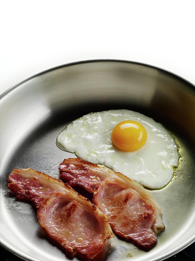 Bacon And Eggs Cooking In A Frying Pan by Patrick Llewelyn-davies/science  Photo Library