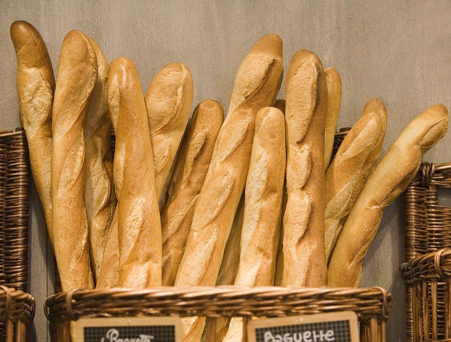 Baguettes in basket in bakery Photograph by Grant V. Faint