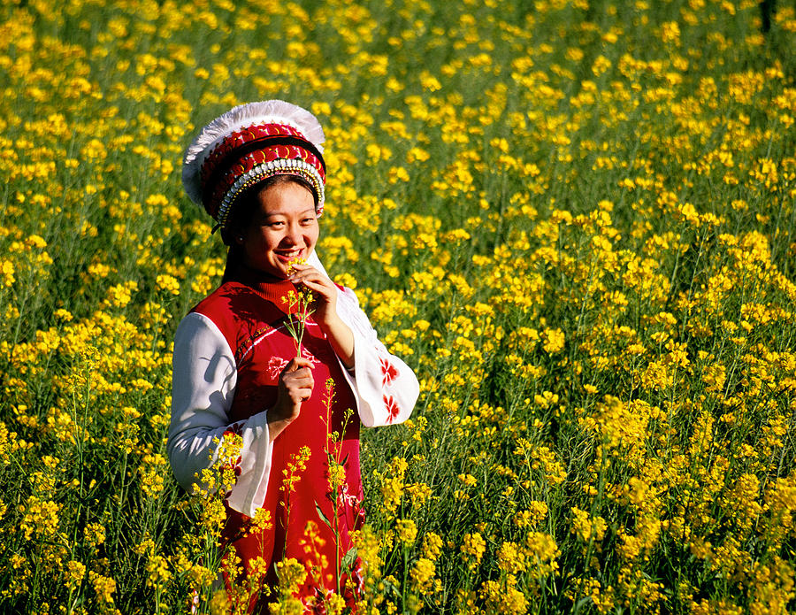 Bai woman in springtime Photograph by Dennis Cox