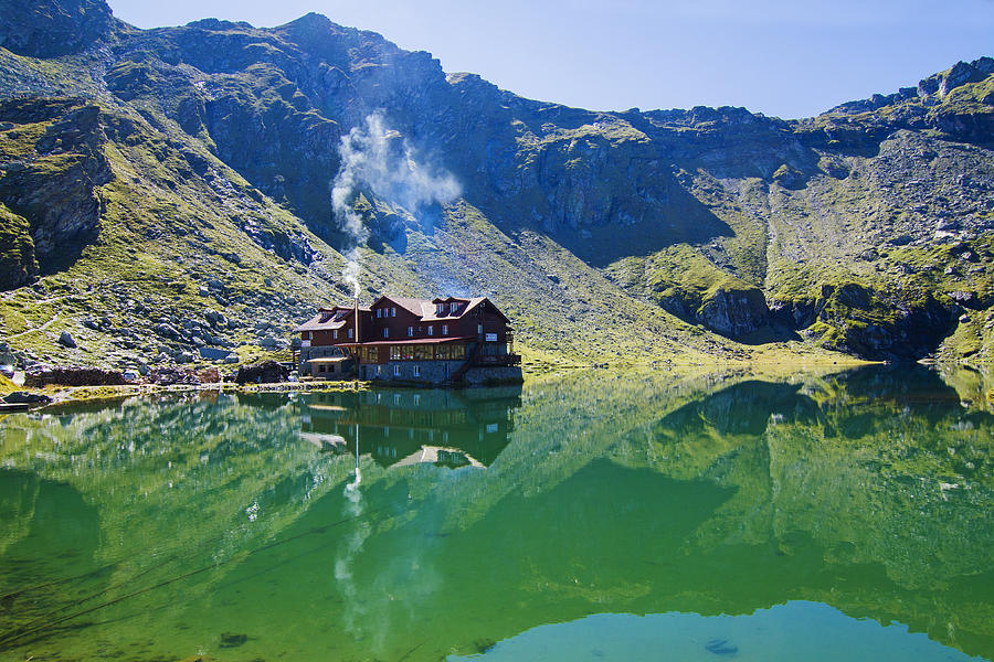 Balea Lake chalet reflection Photograph by Mircea Costina Photography